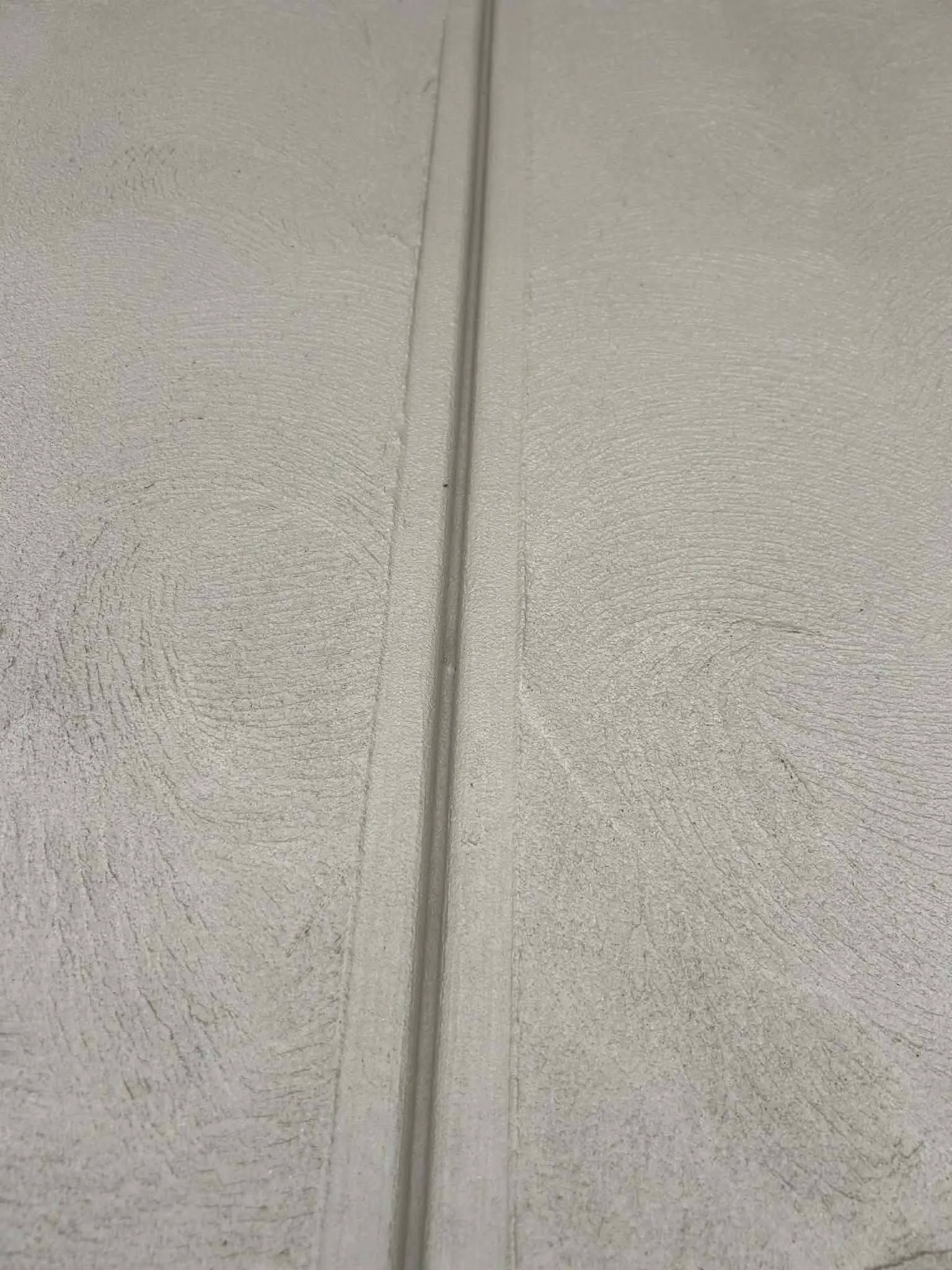 Close-up of a neatly tooled control joint in a freshly finished concrete surface