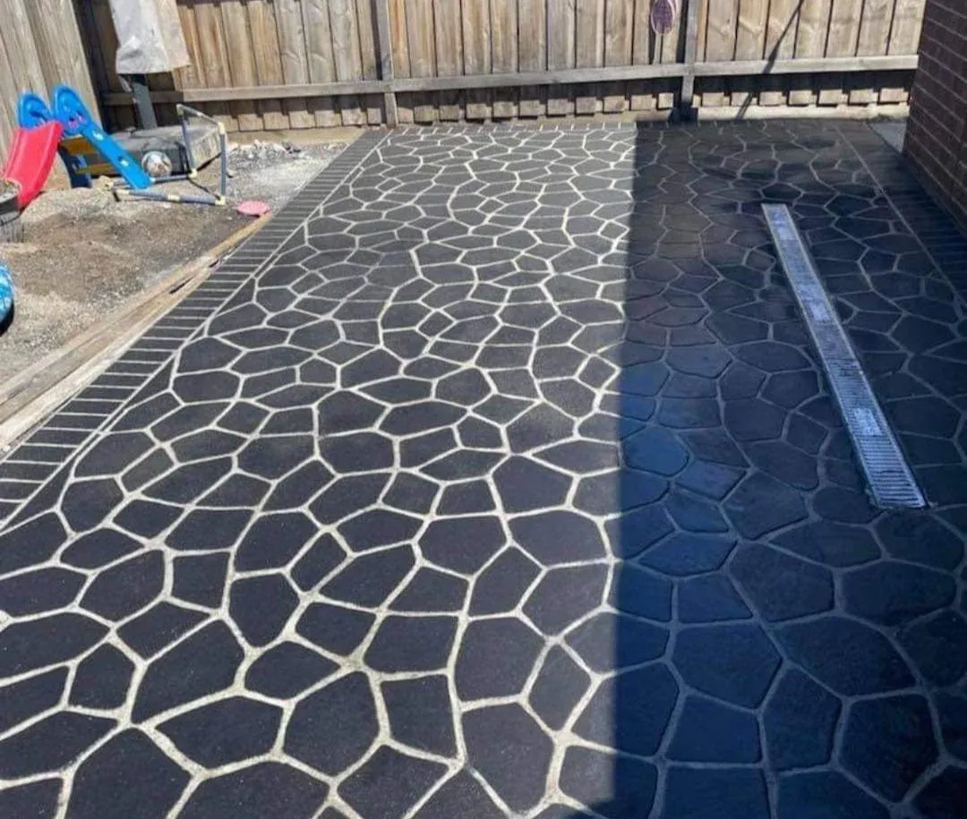 Patterned charcoal stencil-finish concrete in a crazy-paving design with a drainage channel