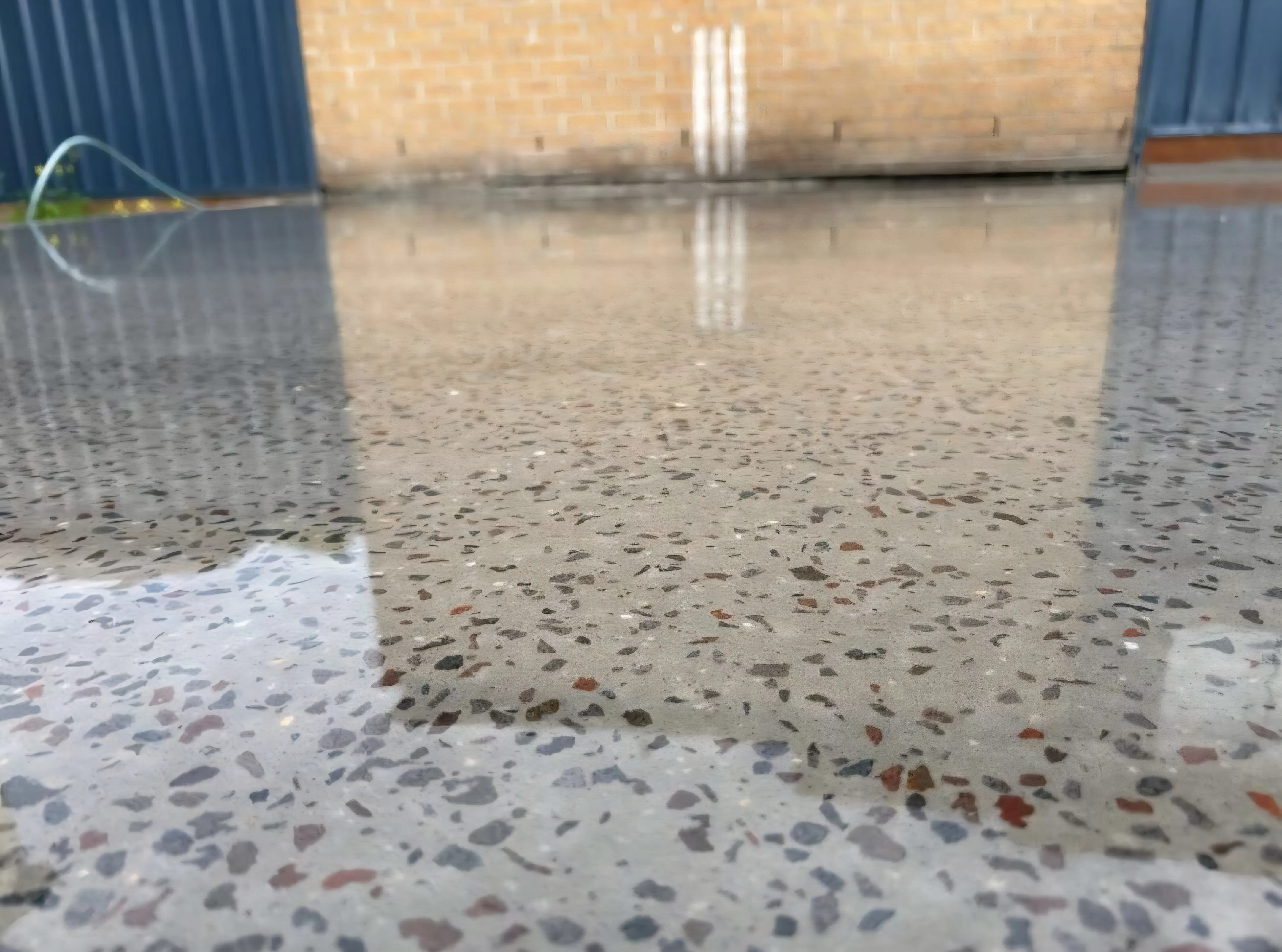 Polished concrete floor with exposed multicoloured aggregate ground to a mirror finish